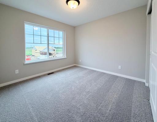 PHOTO OF A DIFFERENT HOME WITH SIMILAR PLAN. FINISHES MAY VARY. Bedroom 3.
