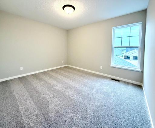 PHOTO OF A DIFFERENT HOME WITH SIMILAR PLAN. FINISHES MAY VARY. Bedroom 2.