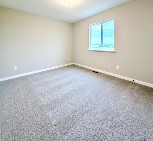 PHOTO OF A DIFFERENT HOME WITH SIMILAR PLAN. FINISHES MAY VARY. Bedroom 4.