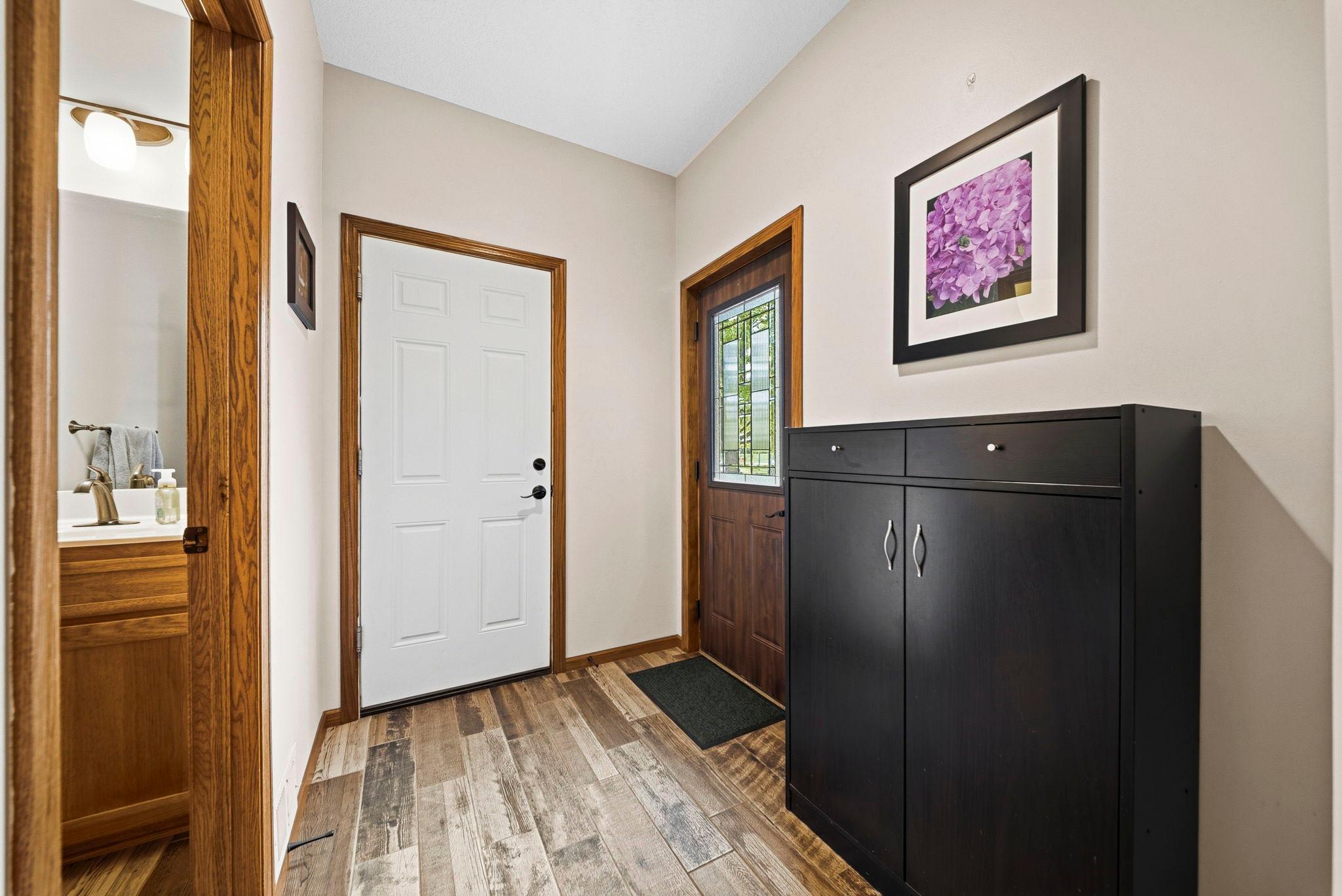Convenient side entry offers a mudroom space, powder room and adjacent laundry room.