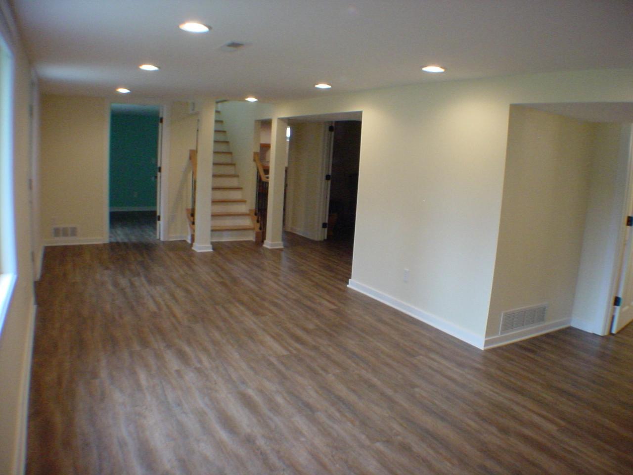 L-shaped family room just off lower level full bath. Great room for a movie night sleep over or guest to retreat.