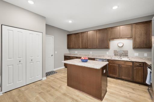 View into kitchen - note double coat closet and door to 2 car garage