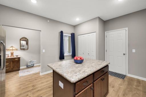 Large center island with storage and room for eat-in seating - window view to front covered patio