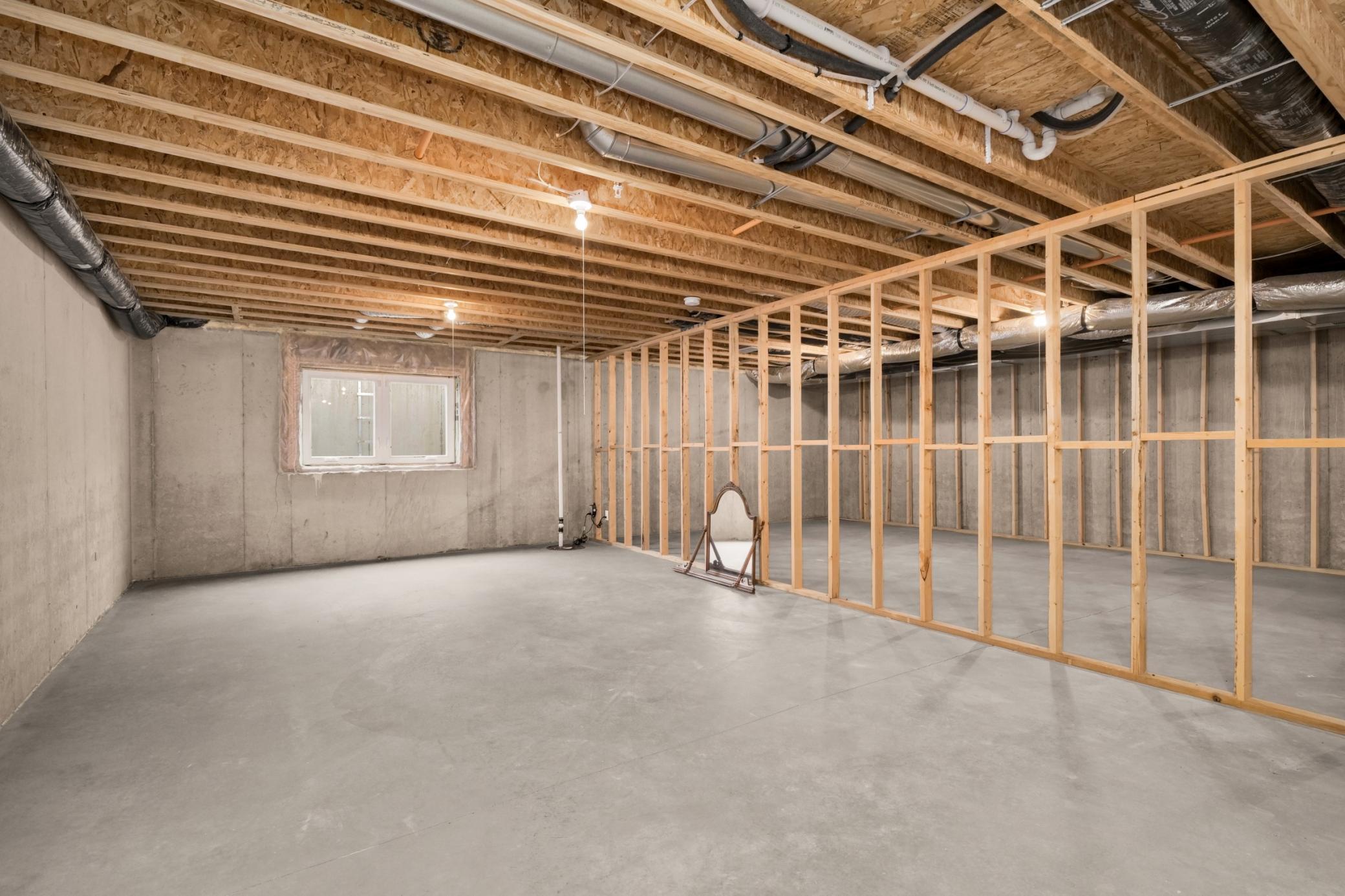 Unfinished lower level awaiting a bedroom, bathroom, family room, and large storage area