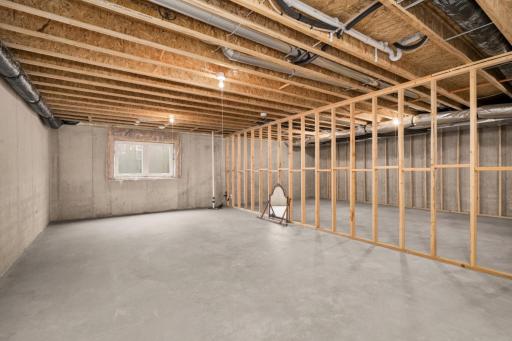 Unfinished lower level awaiting a bedroom, bathroom, family room, and large storage area