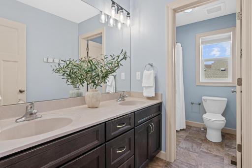 Upper level full bath makes for easy sharing with dual sinks and a door btwn the vanity and tub area.