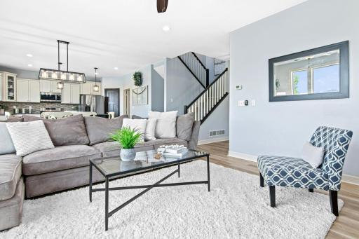 Open concept layout between your kitchen, dining and living room spaces. Note the open staircase that continues to the upper level.