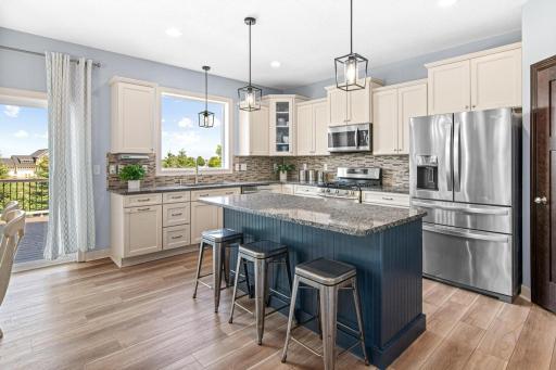 Upgraded kitchen cabinets with crown molding and staggered cabinetry. Stainless steel appliances with gas stove and a large center island for additional prep area.