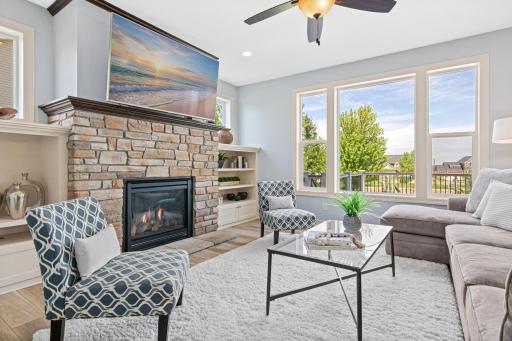 Main floor living room offers a comfortable place to unwind with your gas fireplace with stone surround and built-in cabinets.
