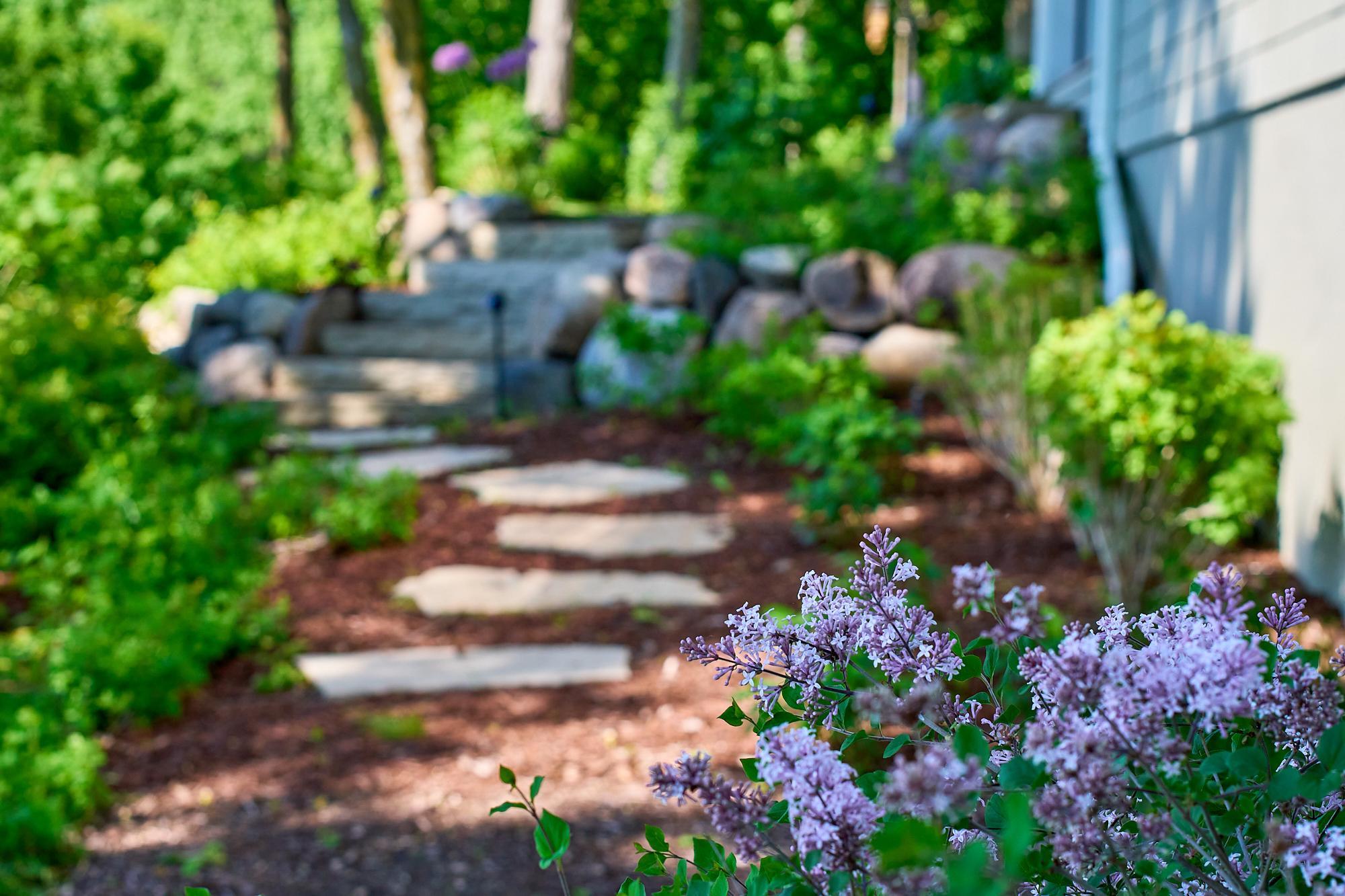 Stone steps and multiple rock walls add a natural touch to the regraded yard.