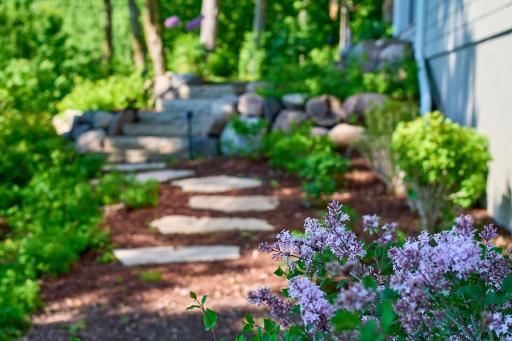 Stone steps and multiple rock walls add a natural touch to the regraded yard.