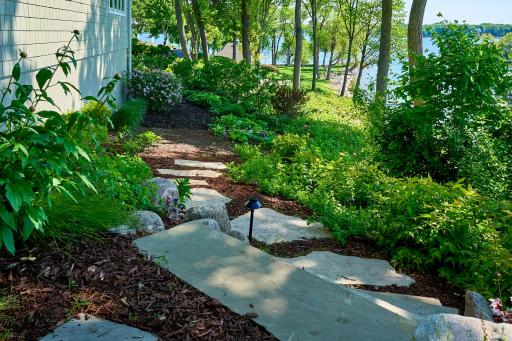 Professionally landscaped to blend with the natural plants along the shore while maintaining a groomed & cared for look