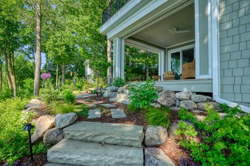 This entire yard was professionally regraded and set in place by Mangold Horticulture - multiple tiered boulder walls, a timed sprinkler system, timed landscape lighting, and stone steps designed with natural elegance in mind.