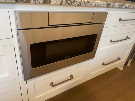 Sharp undercounter microwave oven sits perfectly in the custom kitchen cabinetry