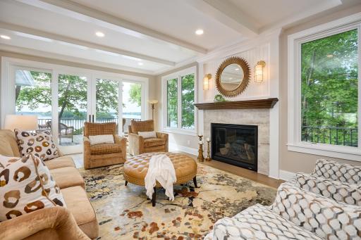 Relax in the living room by the gas fireplace and enjoy lake views through the new four-panel sliding patio doors.