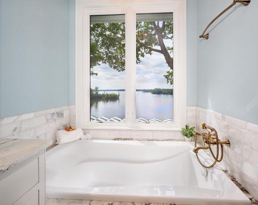 Deep soaking tub in the Main floor Primary Suite Private Bathroom. A comfortable tub & a stunning view!