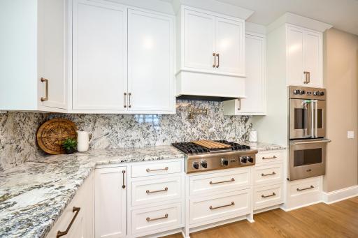 Viking gas cooktop with griddle and a pot-filler, Viking professional dual-wall ovens.