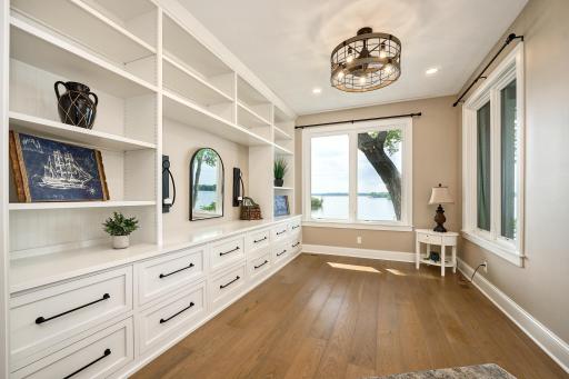 Bedroom 4 is on the walkout-level with stunning lake views. With custom-built-in cabinetry and deep storage drawers, the bedroom could double as a home office or study.