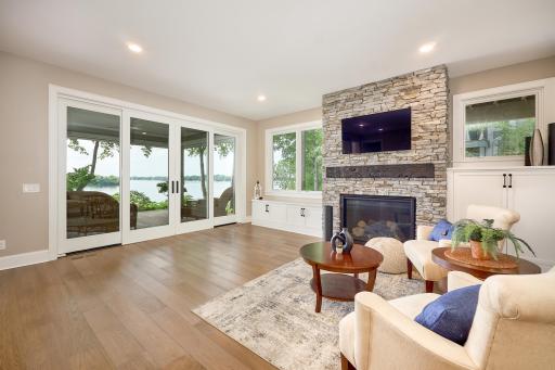 Gas fireplace in the walkout-level Family Room. Beautiful lake view through the oversized four-panel sliding patio doors.