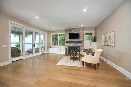 Walkout-level Family Room, built-in cabinetry, recessed lighting, white oak flooring, direct-vent gas fireplace, and step out to the lower deck through new four-panel sliding patio doors. Ceiling is insulated to reduce sound between floors.