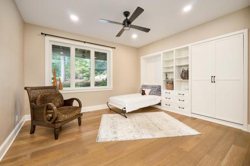 Bedroom 2 is on the walkout-level. Custom-built-in cabinetry includes two extra-long twin Murphy beds, making this an ideal exercise room that can double as a guest room. Beautiful views of the tiered boulder landscaping and the perennial gardens.