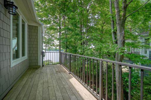 Side deck tucked in the trees off the kitchen is plumbed with natural gas for grilling