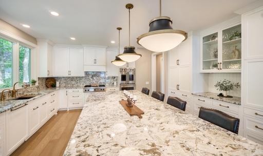 Magnificent center island is ready for baking projects, rolling out cookies, informal potlucks, and formal happy hour gatherings. Just steps from the side deck, it is also a wonderful prep station for grilling.