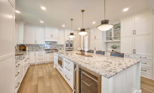 Chef's kitchen with custom cabinetry & Sharp under-counter microwave, Bosch dishwasher, Zephyr beverage refrigerator, Wine refrigerator
