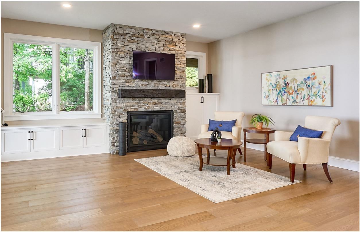 The family room showcases rich white oak flooring and a stone-faced, direct-vent gas fireplace, and is elegantly framed by custom built-in cabinetry. An insulated ceiling is designed for exceptional comfort and privacy.