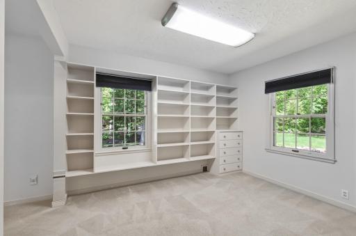Main Floor third bedroom with built in Bookcases