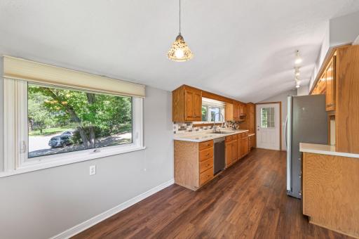 View into kitchen from informal dining/ kitchen eat in area.