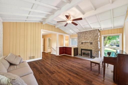 Main Floor Family room with wood burning fireplace, currently housing an electric fireplace insert.