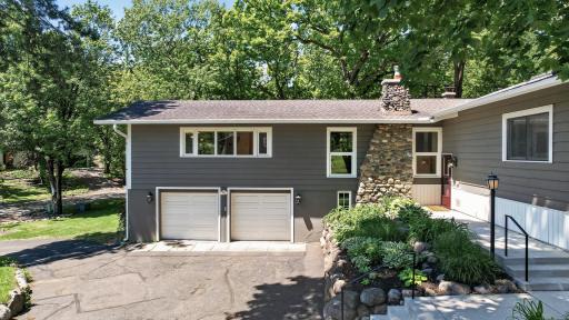 Aerial view of home's front showing two car tuck under garage