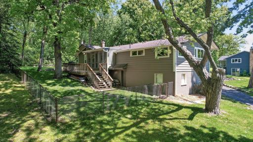 Southwest view of lot, featuring fenced backyard.