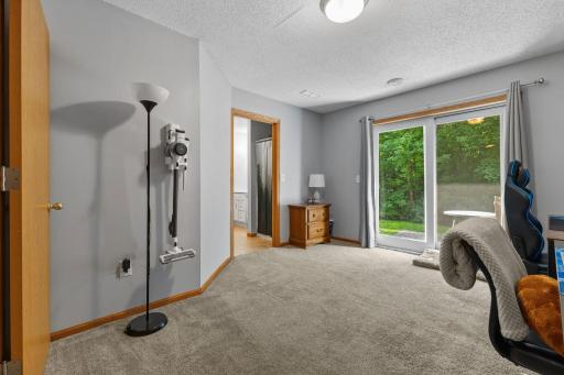 Main-floor bedroom that can also function as an office or family room, with direct walkout access to the backyard patio.