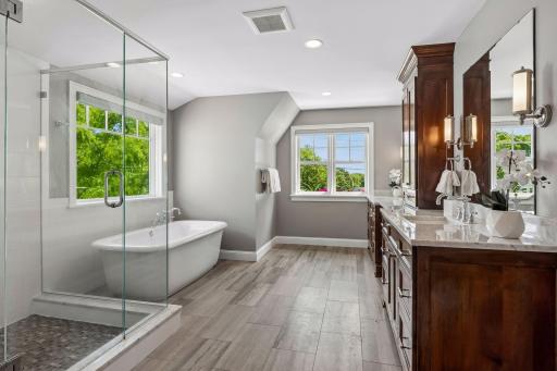 Luxurious primary suite complete with heated floors