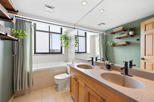 Full bath with deep soaking tub and dual sink vanity