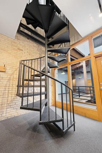 Party room with spiral staircase to upper level deck