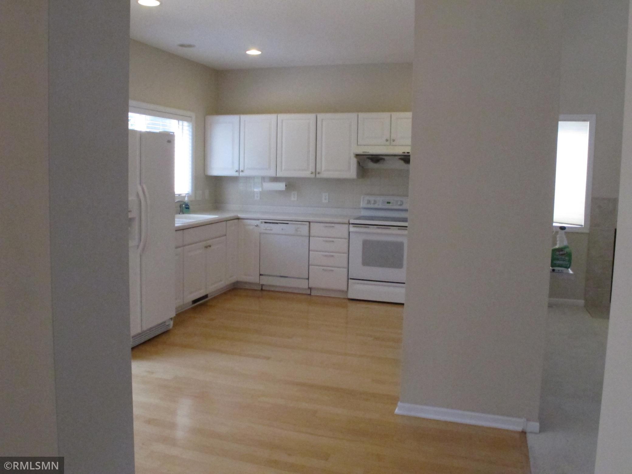 Spacious Kitchen with roll out lower cabinets & stainless steel refrigerator