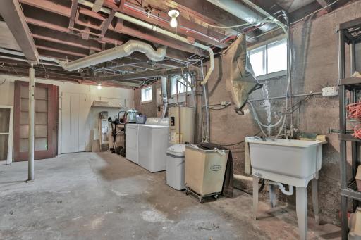 Laundry area in basement - also extra storage space