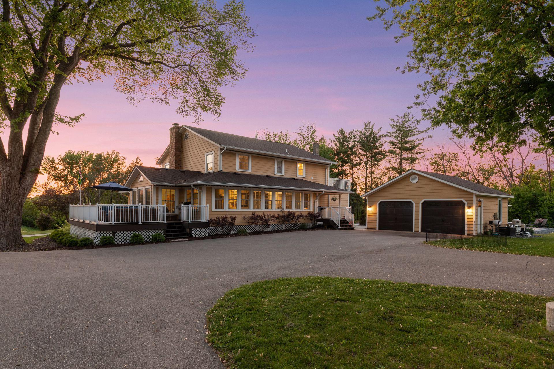 The front porch, side deck, sunroom and rear three-season porch wrap around the home, maximizing views and offering great outdoor living spaces.