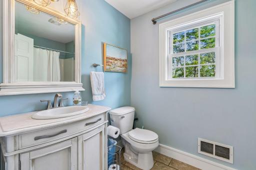 It is located near the main floor bathroom which is a full bath with a tub/shower combination and ceramic tile flooring.