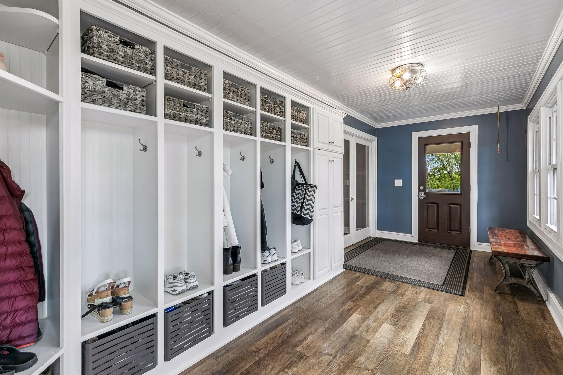 At the rear of the home is a three-season porch and mudroom. The updated exterior door leads to a small back deck and entrance while the double French doors enter the home via the kitchen.