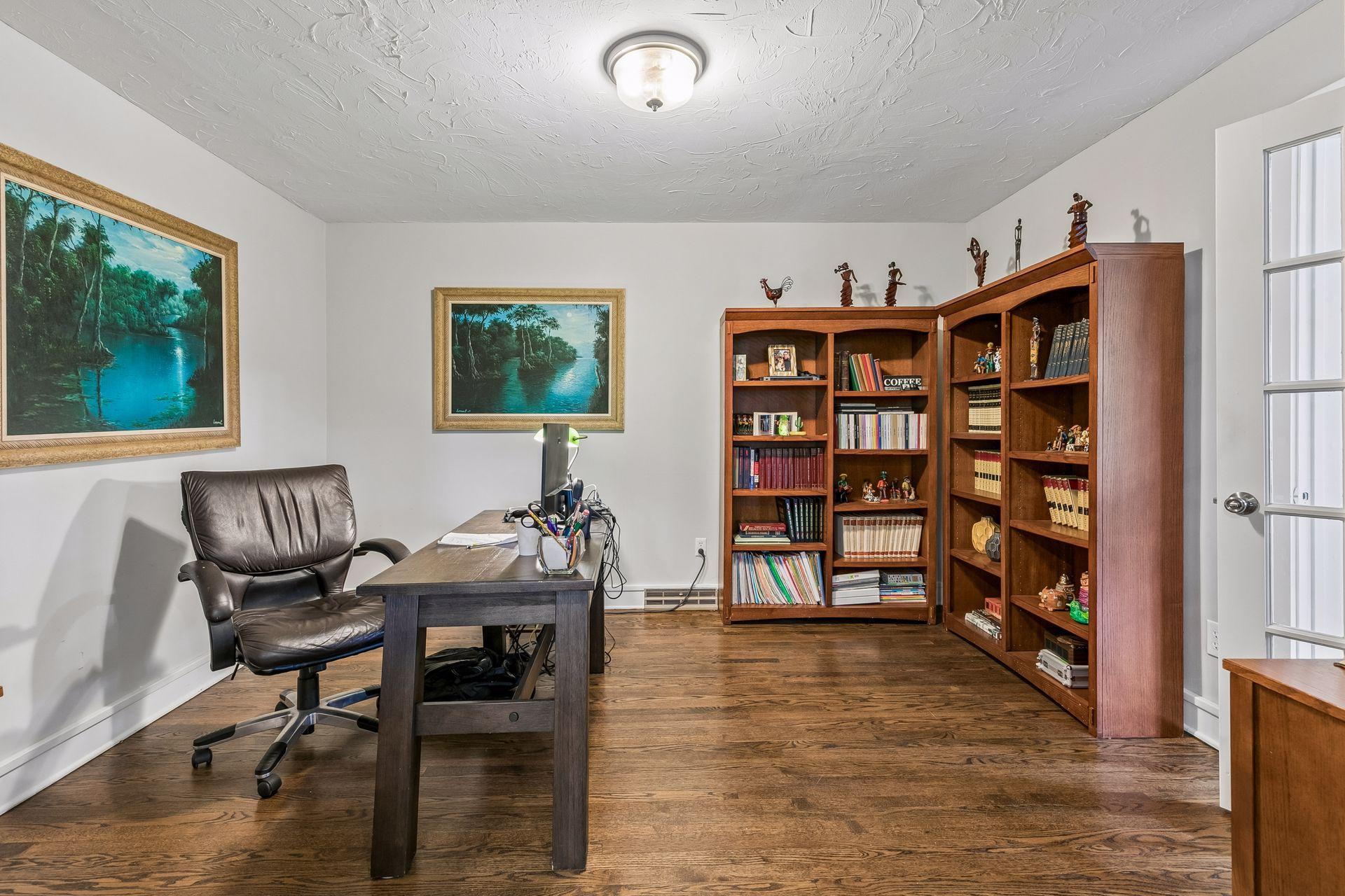 The study is situated between the living room and sunroom. It receives natural light via the French door to the sunroom.