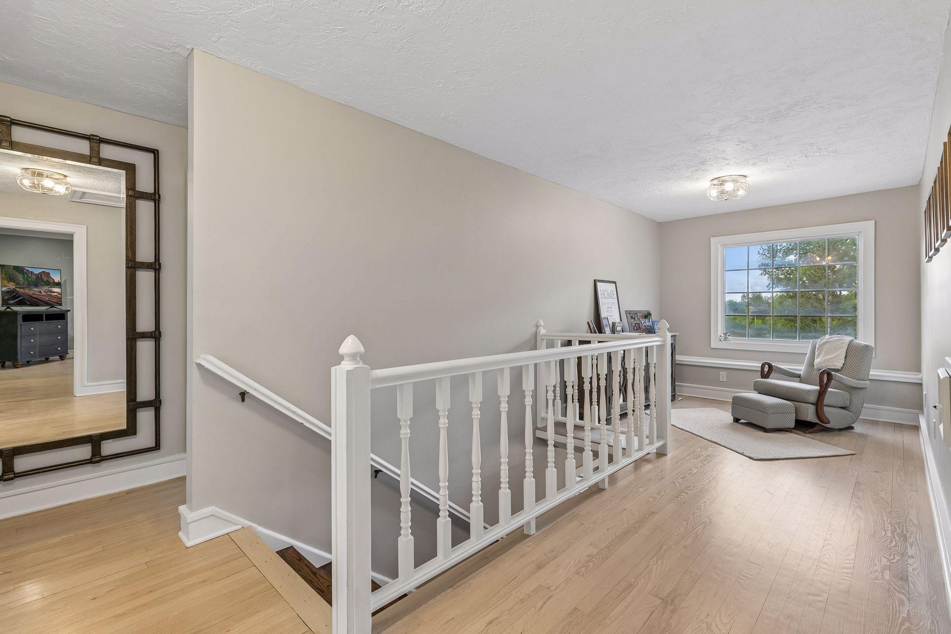 The upper level has lighter toned hardwood floors throughout. There is a small loft and flex space at the top of the stairs.