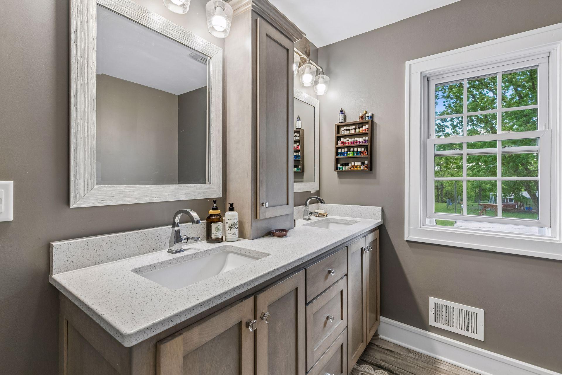 The primary bath has a quartz vanity with dual sinks and plentiful storage.