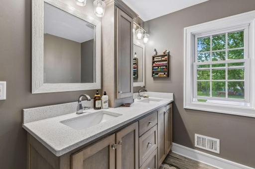 The primary bath features a Shaker-style dual-sink vanity with abundant storage.