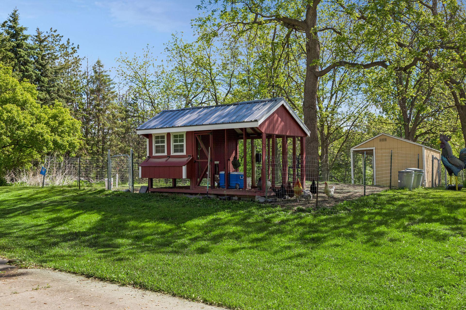 A fenced area contains two chicken coops.