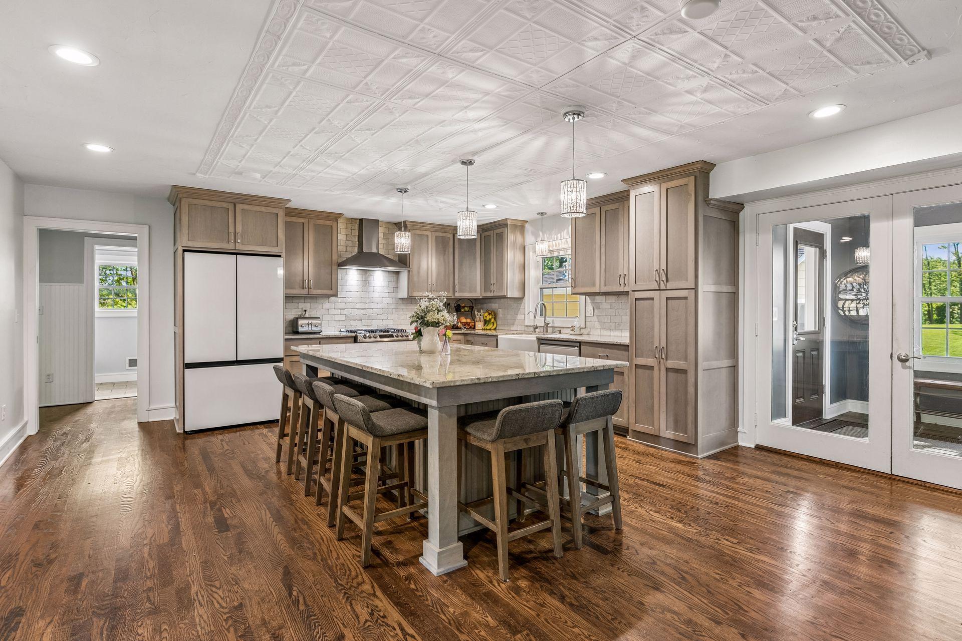 The kitchen has Shaker style cabinetry with quartz counters and a tile backsplash.