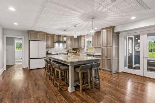 The kitchen has Shaker style cabinetry with granite counters and a tile backsplash.